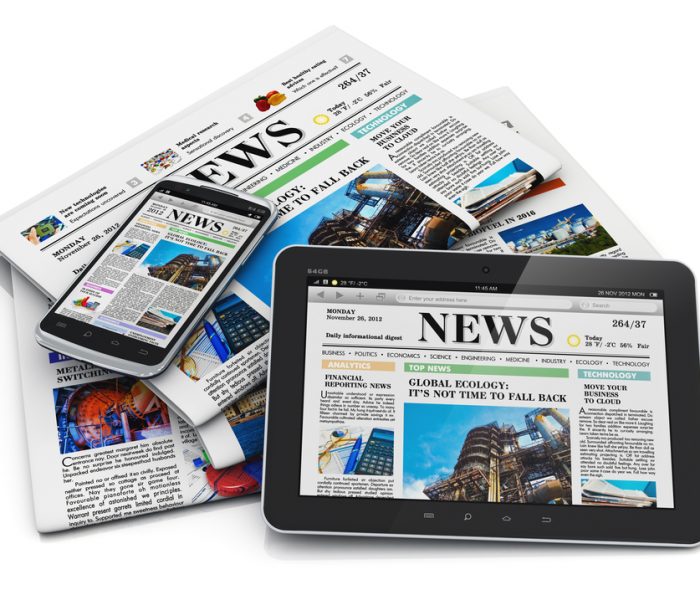 Electronic internet web and paper media concept: tablet PC computer, modern black glossy touchscreen smartphone and heap of businees office newspapers with financial news isolated on white background with reflection effect